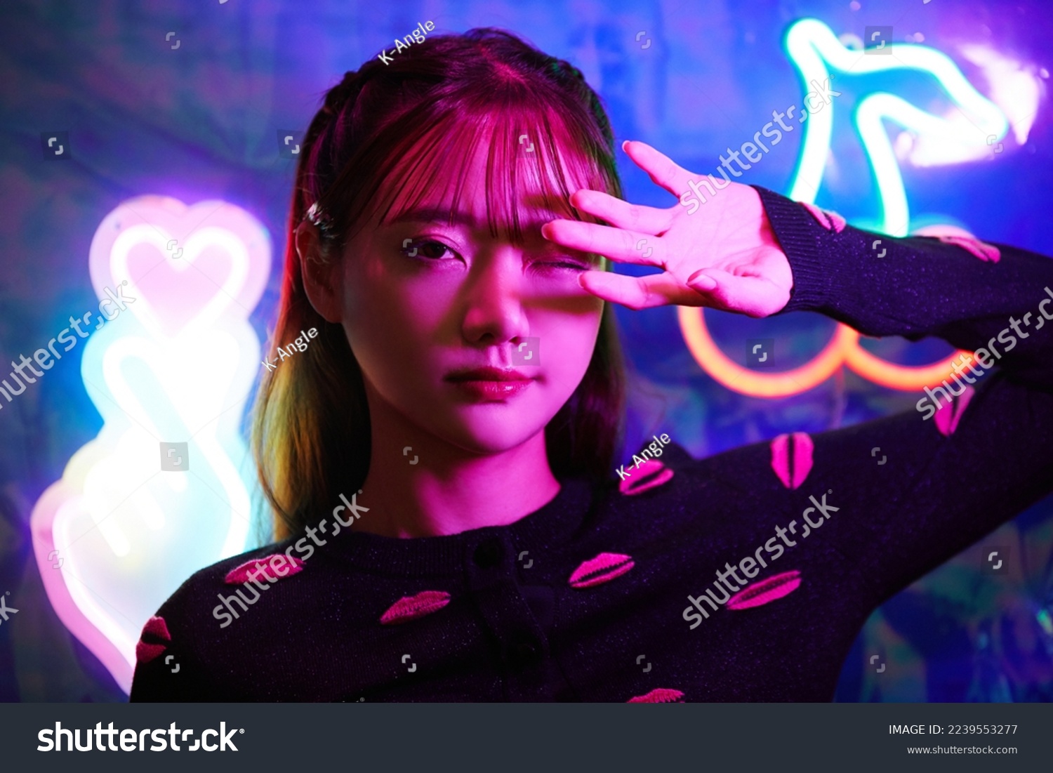 Portrait of a young Asian woman with neon sign #2239553277