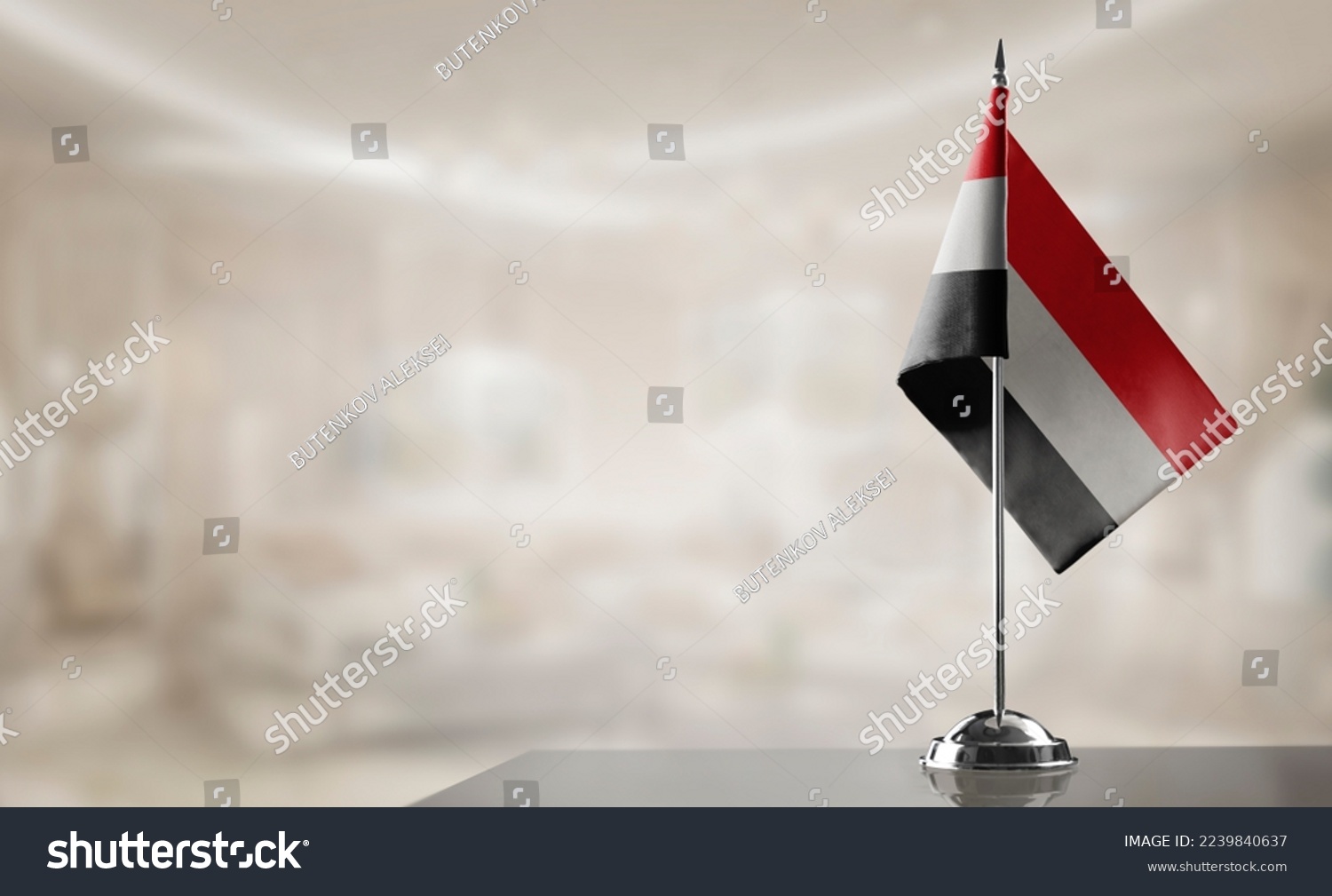 A small Yemen flag on an abstract blurry background #2239840637