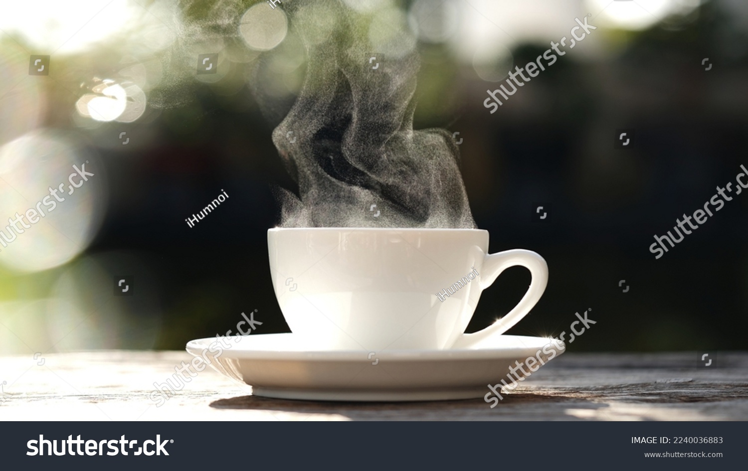 Close-up white coffee cup, mug with steaming smoke of coffee on old wooden table in morning nature outdoor, garden background, 4K. Hot Coffee Drink, Beverage Concept. #2240036883