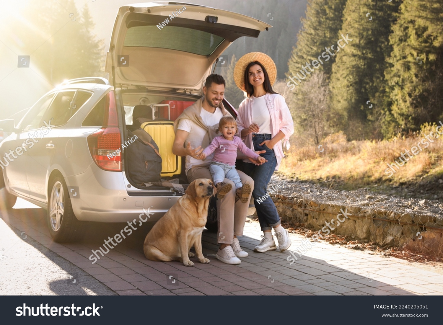 Parents, their daughter and dog near car outdoors. Family traveling with pet #2240295051