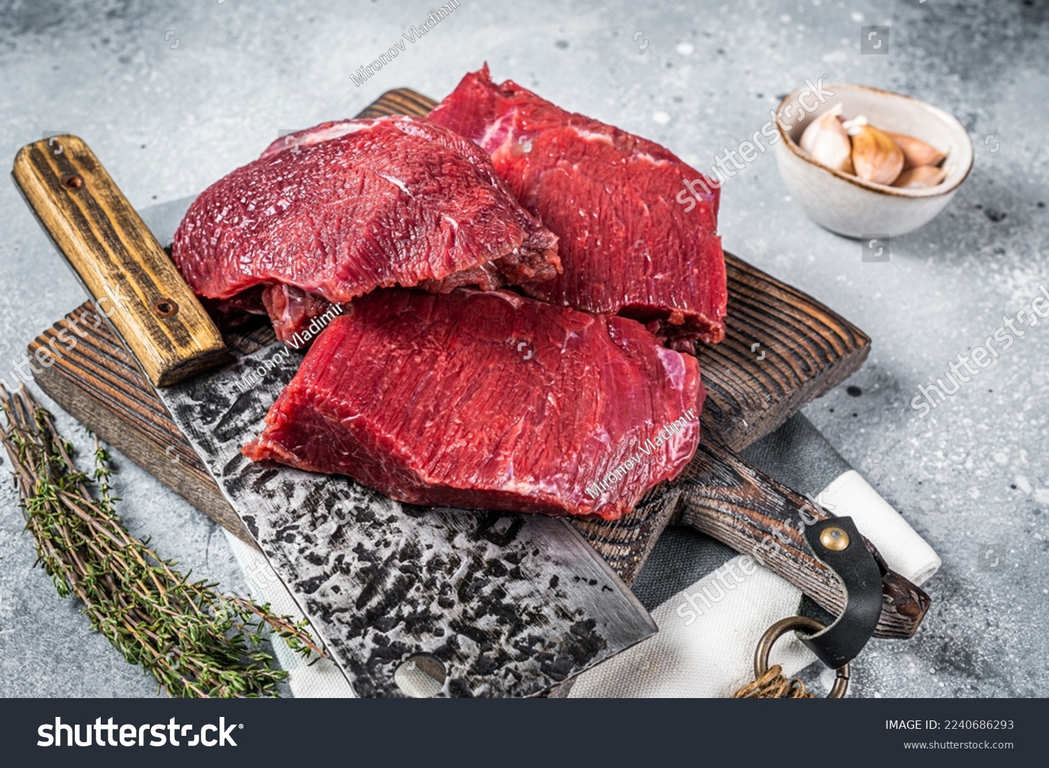 Raw Venison dear meat on butcher cutting board, game meat. Gray background. Top view. #2240686293
