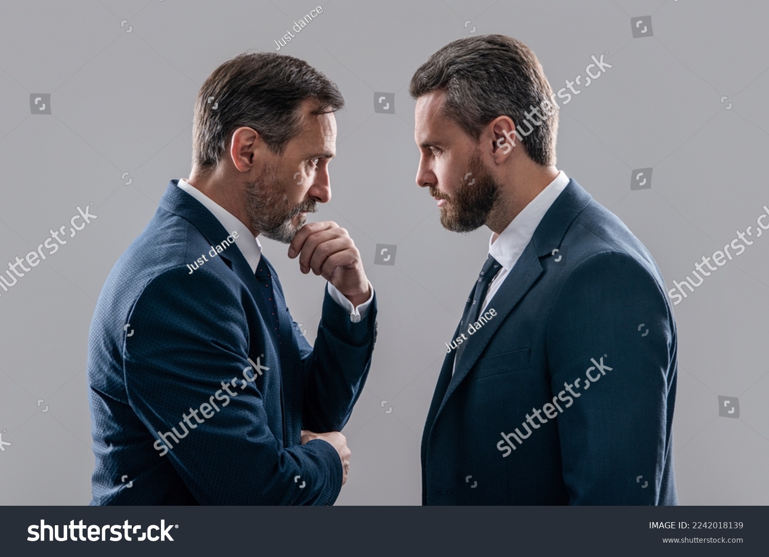 confrontation of two businessmen in suit. photo of businessmen has confrontation look #2242018139