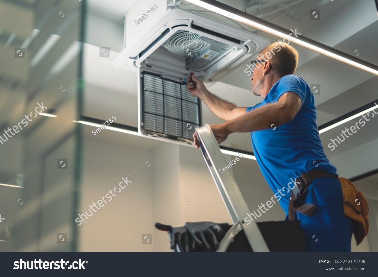 Technical maintenance worker repairs the air conditioning system #2242172789