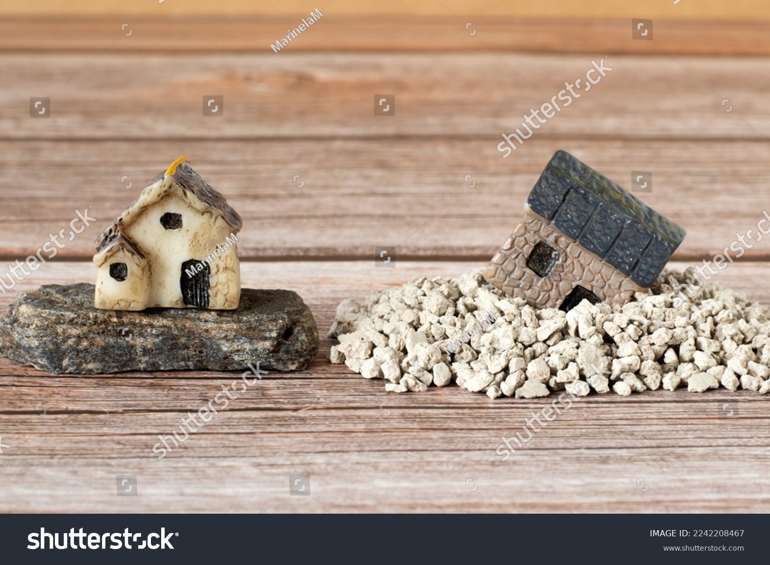 Two miniature houses in sand and on rock (stone). Copy space. A close-up. Solid foundation gospel parable of Jesus Christ, obedience, and faith in God. Christian biblical concept. #2242208467