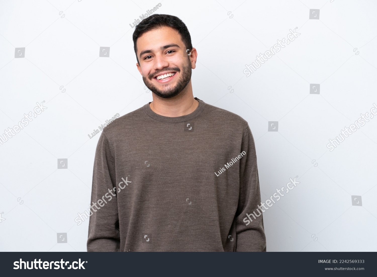 Young Brazilian man isolated on white background laughing #2242569333
