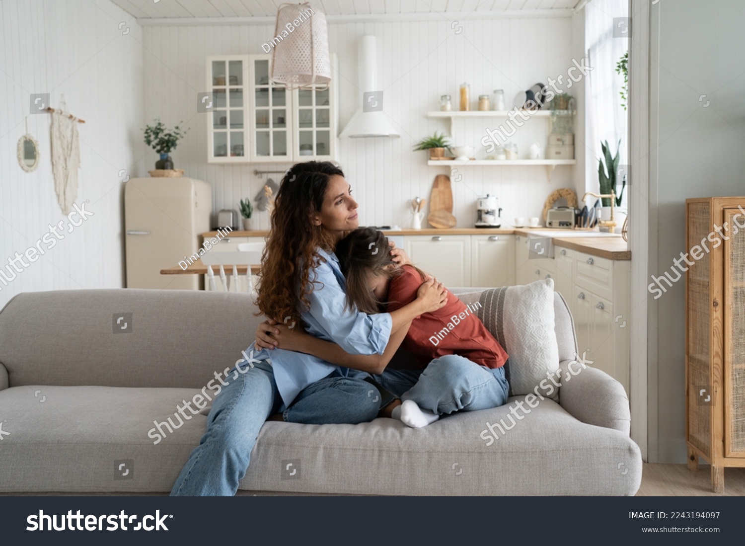 Loving caring mother hugging teen daughter. Parent mom showing understanding and support to upset sad teenage girl. Crying child sharing feelings with mommy while sitting together at home #2243194097