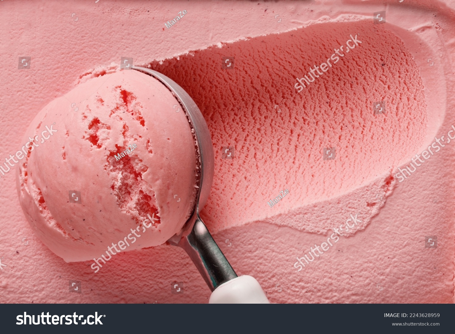 pink strawberry ice cream ball in a spoon, top view #2243628959