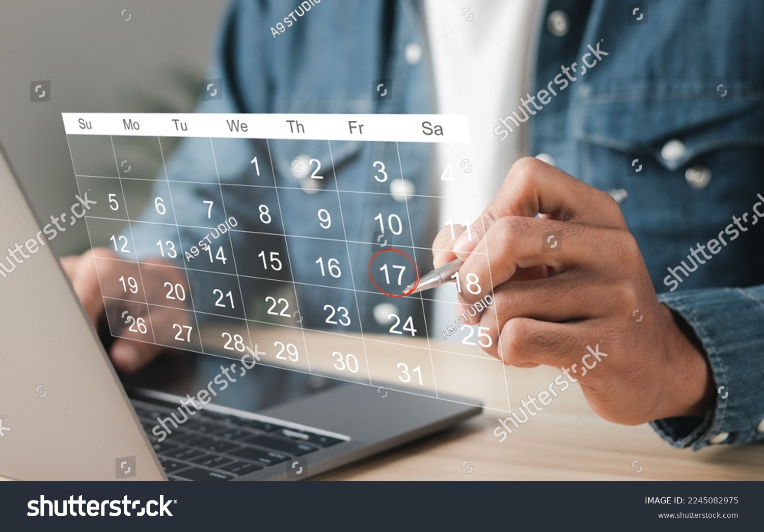 Businessman manages time for effective work. Calendar on the virtual screen interface. Highlight appointment reminders and meeting agenda on the calendar. Time management concept. #2245082975