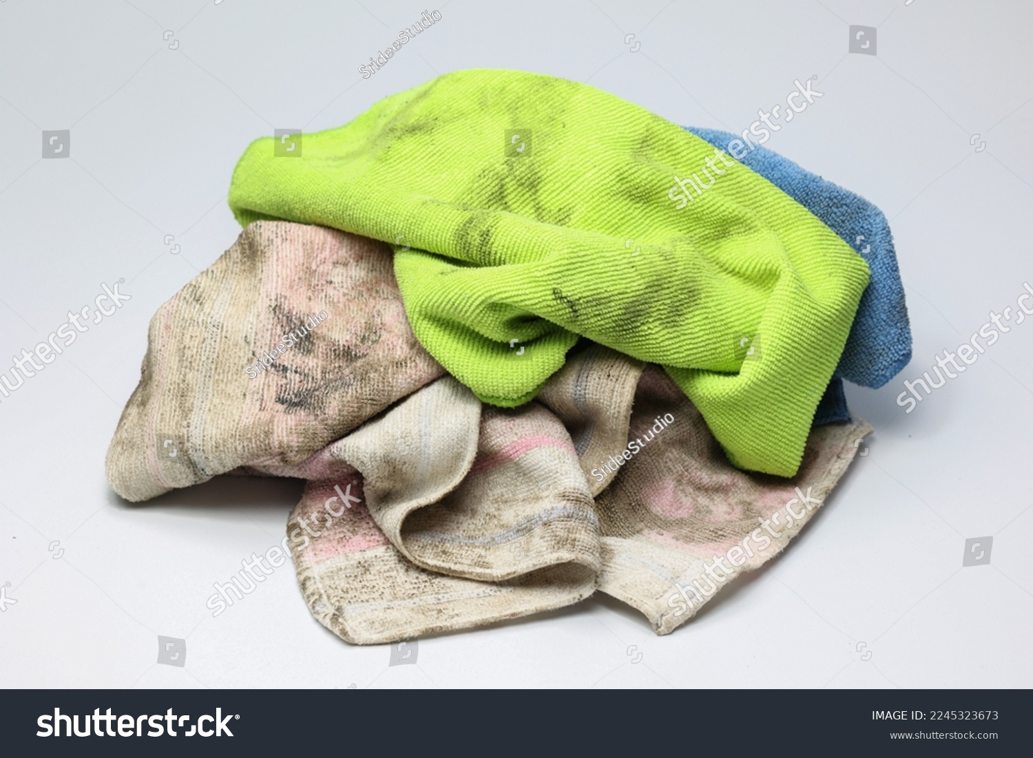 Pile of dirty rag suspended isolated on white background. #2245323673