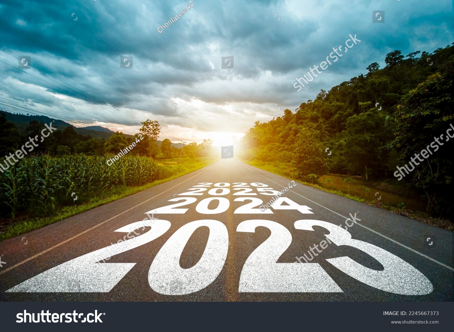 New year 2023 or straight forward concept. Text year 2023, 2024, 2025 written on the road in the middle of asphalt road with at sunset. Concept of planning, goal, challenge, new year resolution. #2245667373
