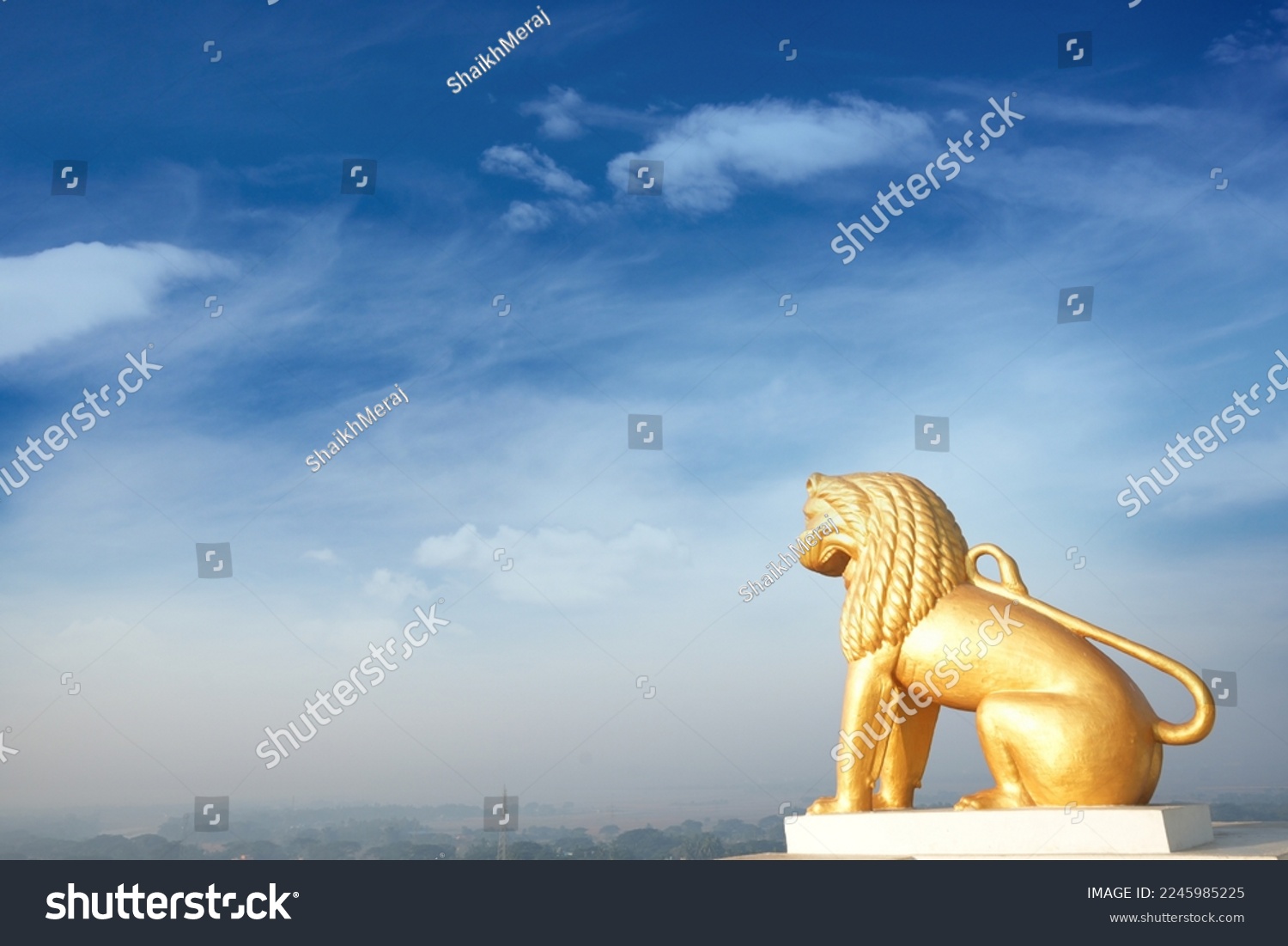 Yellow lion statue isolated on blue sky background at Dhauli Shanti Stupa in Bhubaneswar, Odisha, India. Dhauli or Dhauligiri Buddhist shrine built by King Ashok after the war of kalinga #2245985225