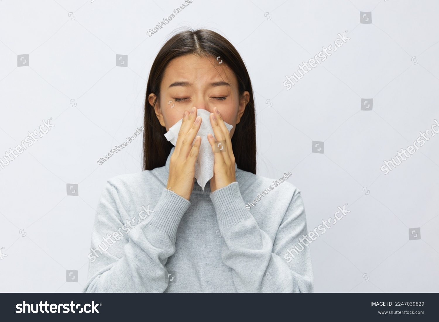 Asian woman holding hand with handkerchief and coughing up flu and cold, stuffy nose viral disease covid 19 white background #2247039829