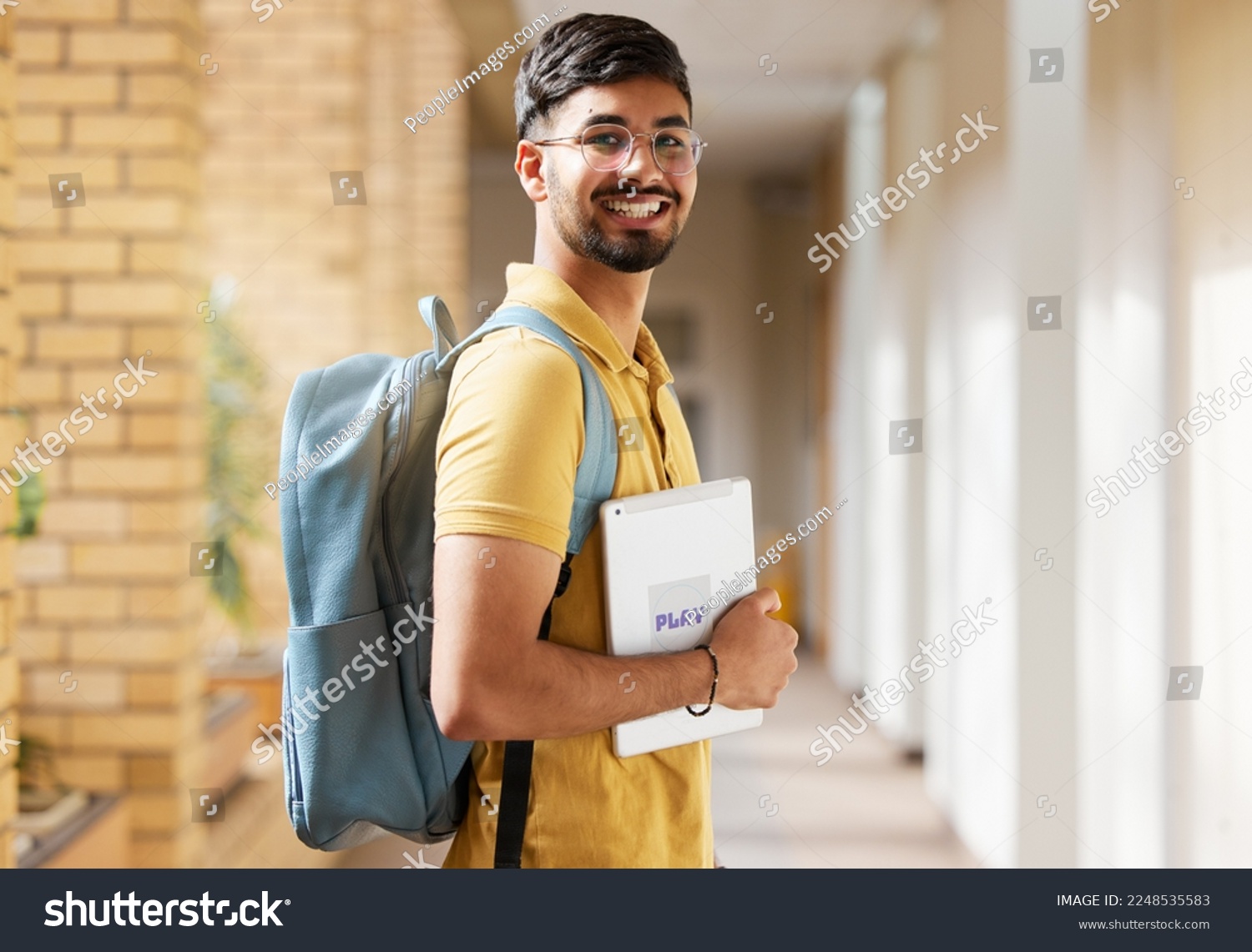 College student portrait, happy man and walking at university with a tablet and backpack to study and learn. Gen z male happy about education, learning and future after studying at school building #2248535583