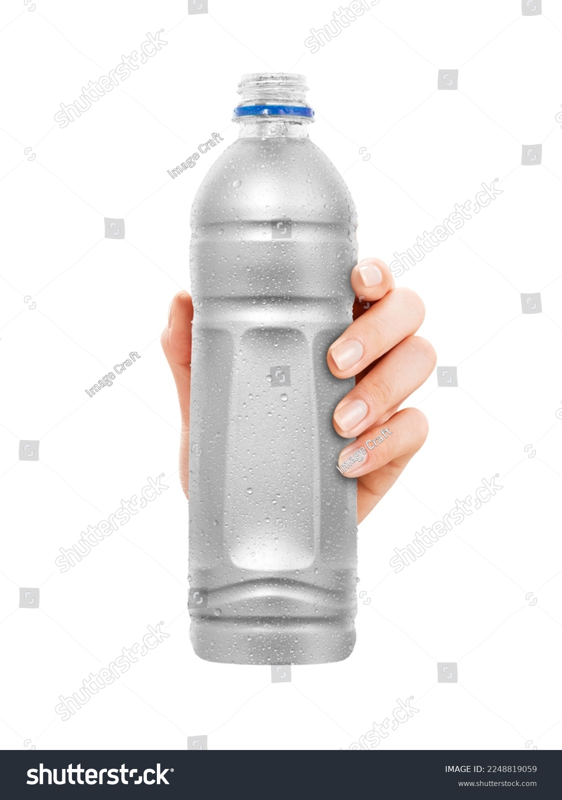 Close-up of hand holding Empty plastic Bottle with condensation. isolated on white Background. front view. #2248819059