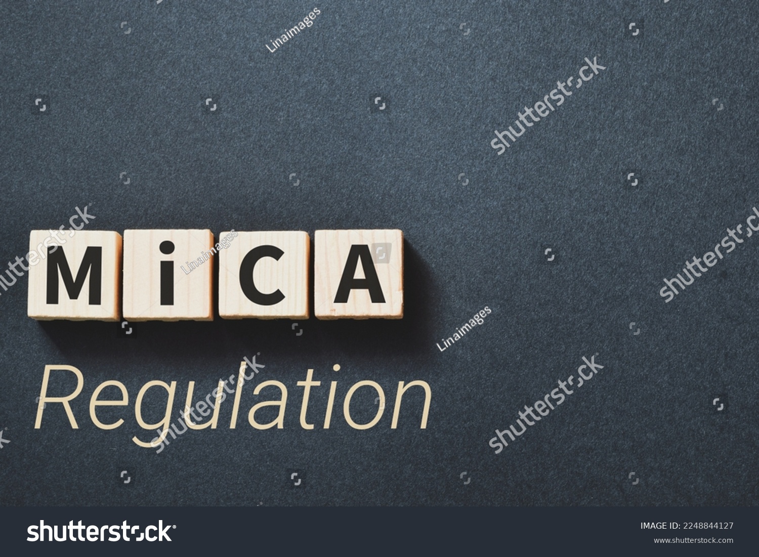 Markets in Crypto-Assets (MiCA) Regulation inscription on wooden blocks on dark background. #2248844127