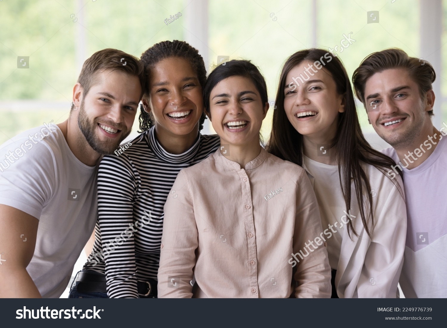 Multiethnic team of joyful happy students, interns, friends posing close together, looking at camera with toothy smiles, laughing, enjoying meeting, social communication, group success #2249776739