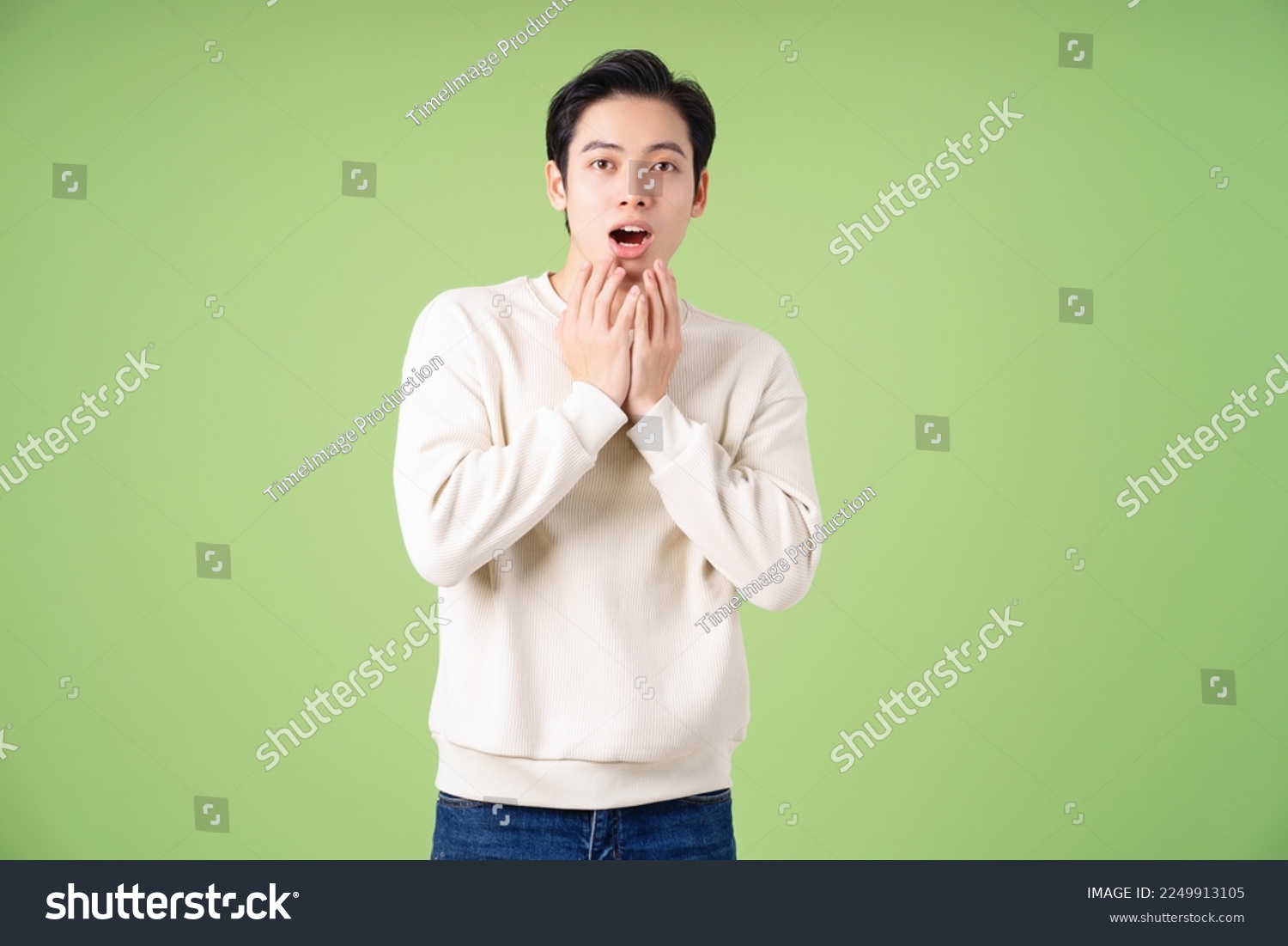 Portrait of young Asian man posing on green background #2249913105