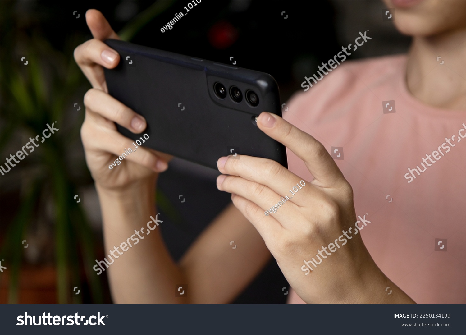 Hands of a girl with a smartphone close-up. Take a selfie on your phone or shoot a video for social networks. Free time on the Internet, instant messengers, smartphone applications. #2250134199