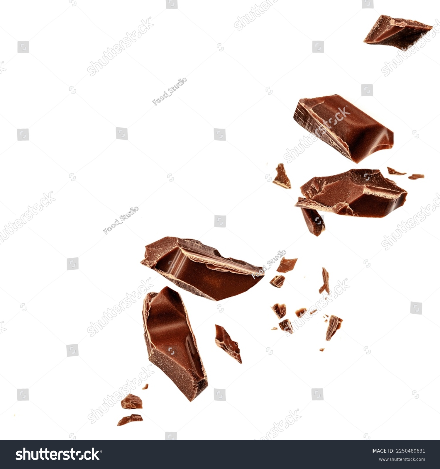  Levitating milk chocolate chunks isolated on white background. Flying Chocolate pieces, shavings and cocoa crumbs Top view. Flat lay
 #2250489631