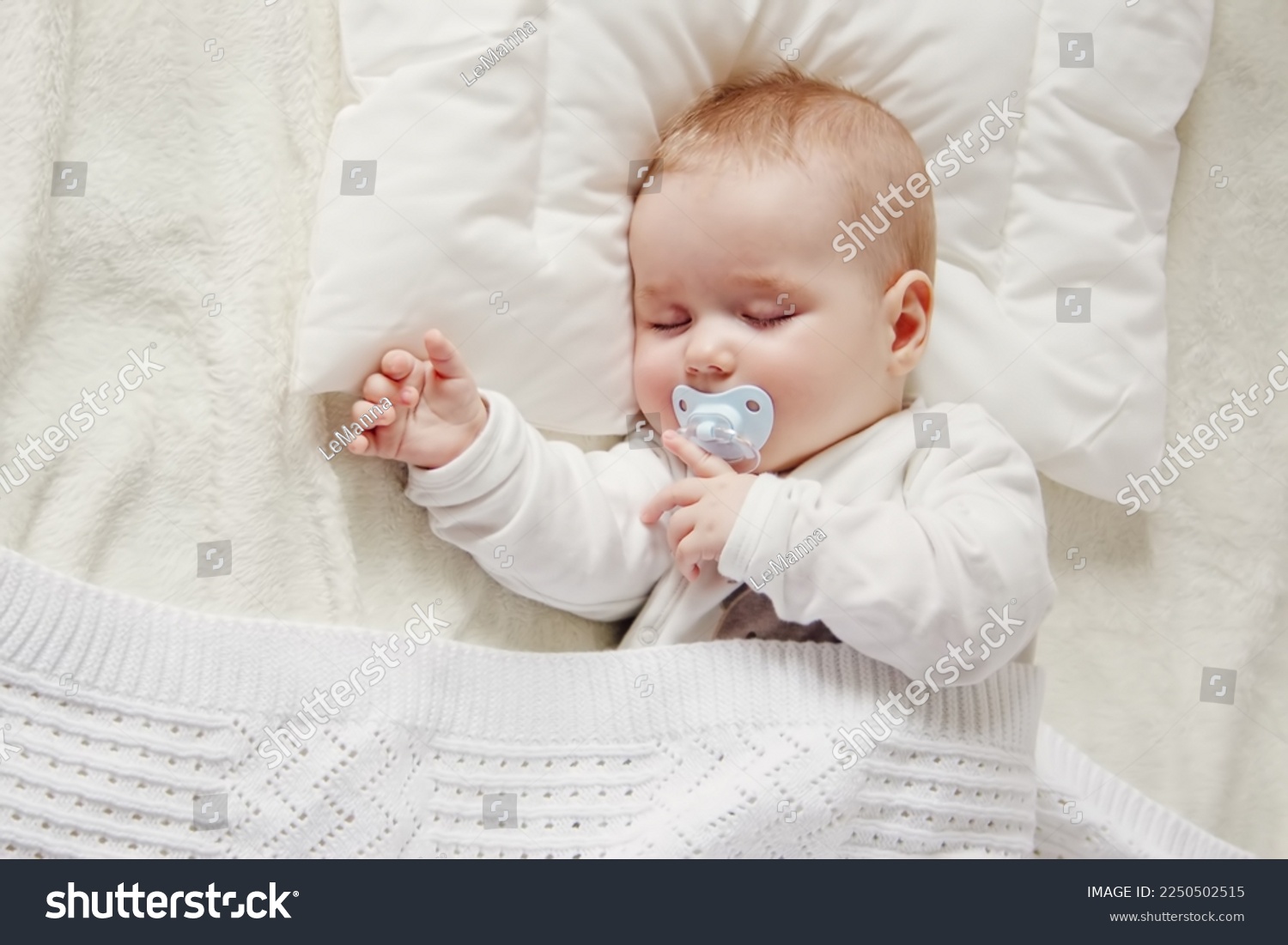 Cute five month old baby sleeping in comfortable bed. Concept of the family andparenting. #2250502515