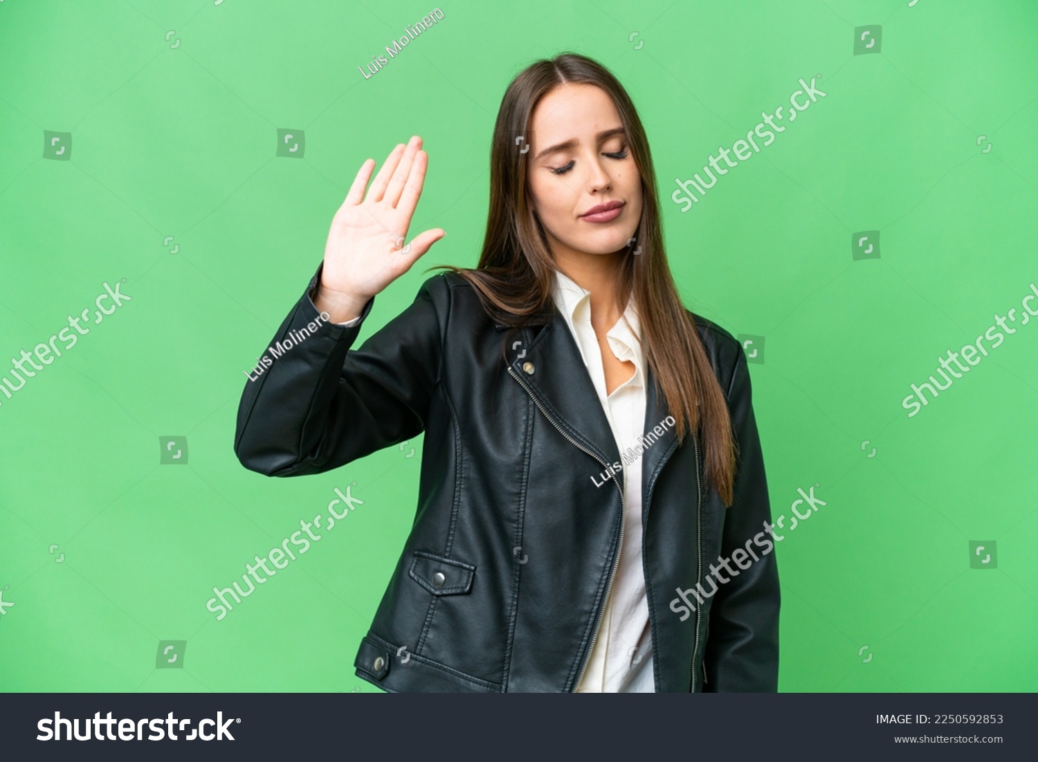 Young beautiful woman over isolated chroma key background making stop gesture and disappointed #2250592853