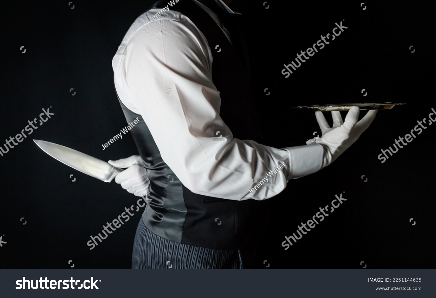 Butler or Waiter With Serving Tray and Holding Sharp Knife Behind Back. Concept of Butler Did It. Classic Murder Mystery. #2251144635
