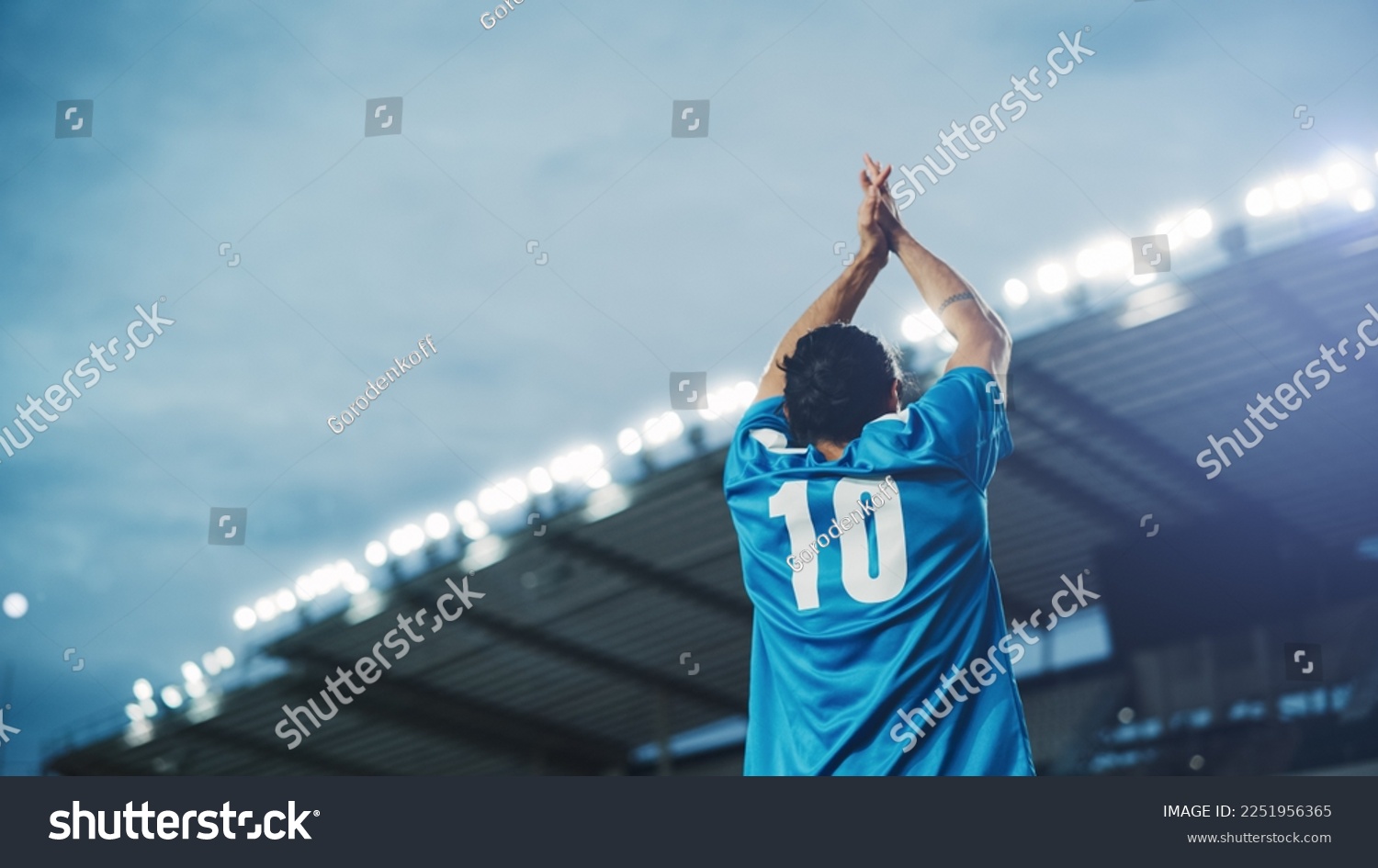 Football Match Championship: Portrait of Soccer Player Standing, Posing, Smiling, Raising Hands to Cheer. Professional Hispanic Footballer, Champion Ready to Win Cup, Tournament. Medium Back Shot #2251956365