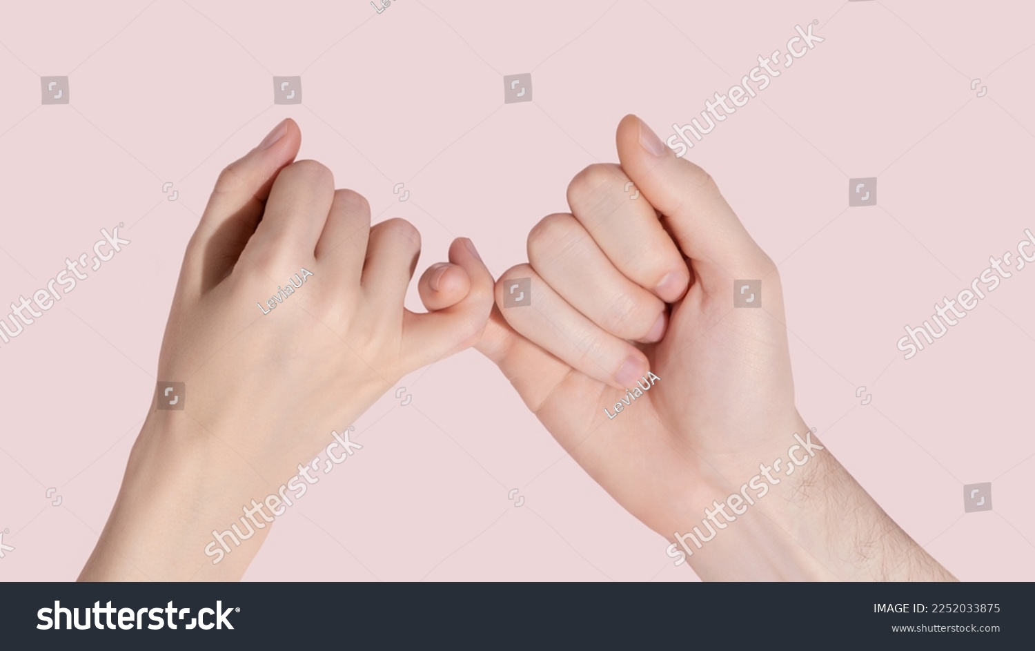 Man and woman hold each other with little fingers. ?oncept of friendly relations. High quality photo #2252033875