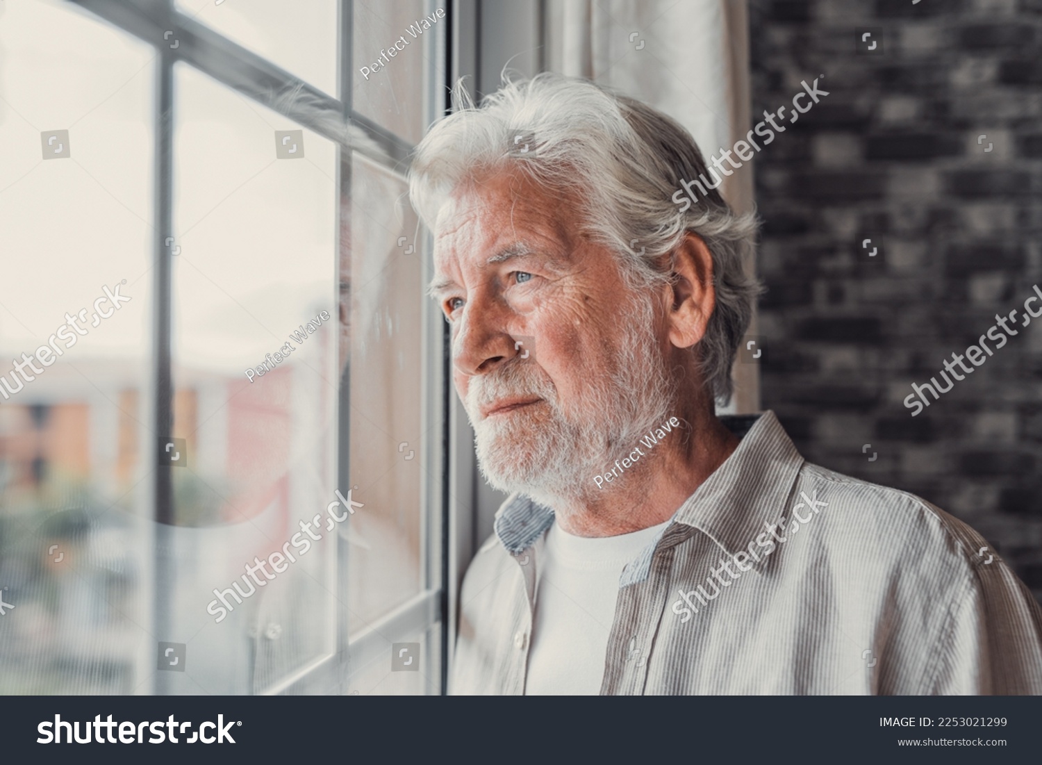 Pensive elderly mature senior man in eyeglasses looking in distance out of window, thinking of personal problems. Lost in thoughts elderly middle aged grandfather suffering from loneliness, copy space #2253021299