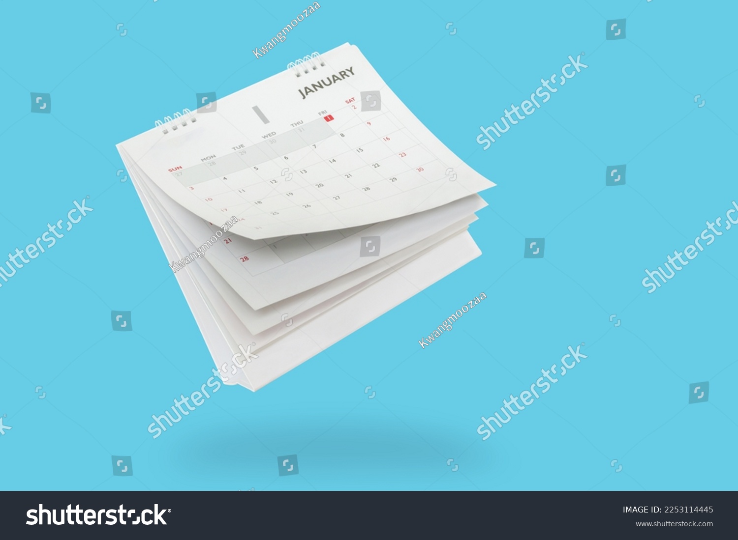 White paper desk calendar flipping page isolated on blue background #2253114445