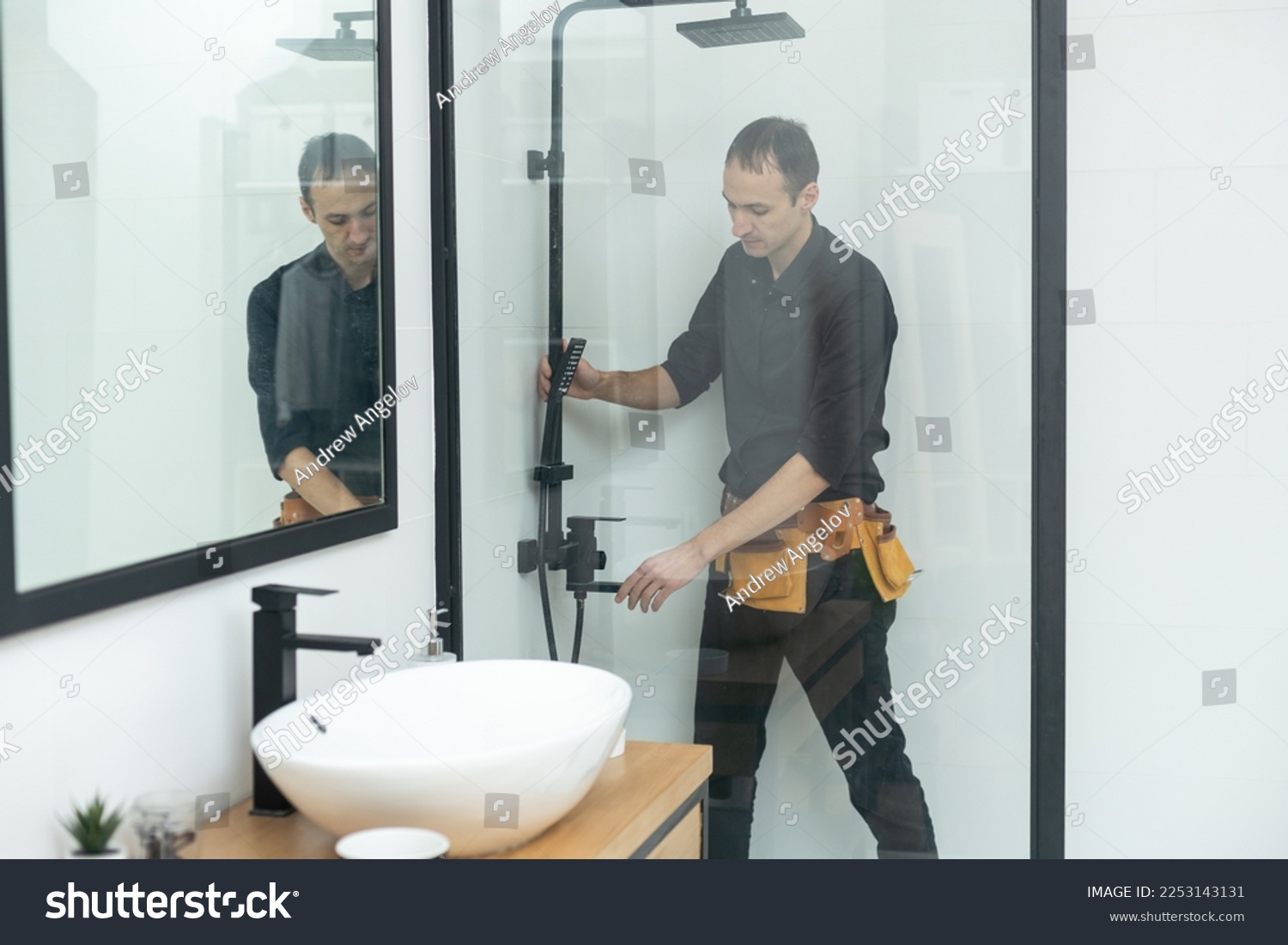 Plumber installing a shower cabin in bathroom #2253143131