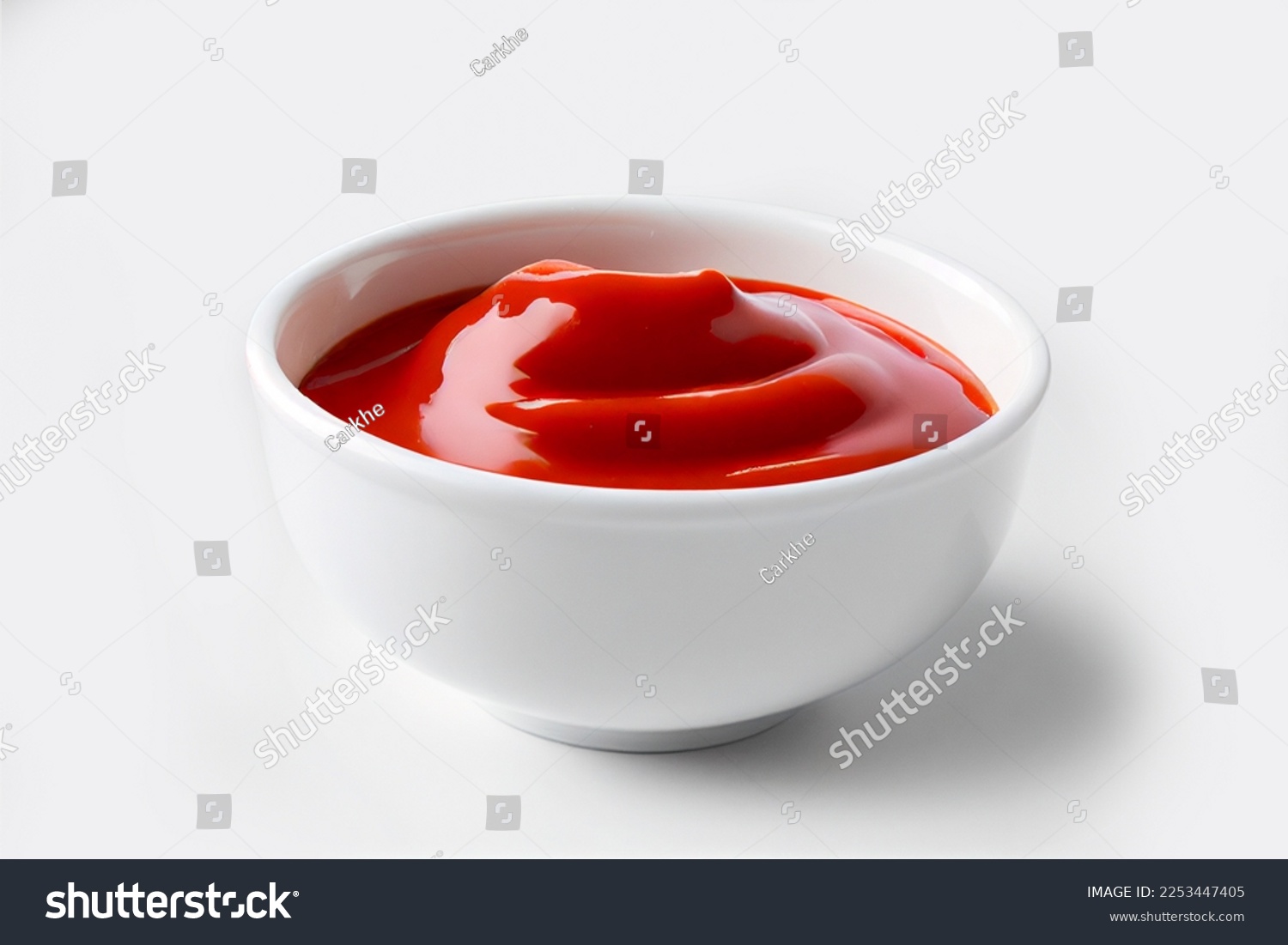 Delicious ketchup in white bowl isolated on white background. Portion of tomato sauce with clipping path. Collection of various sauces #2253447405