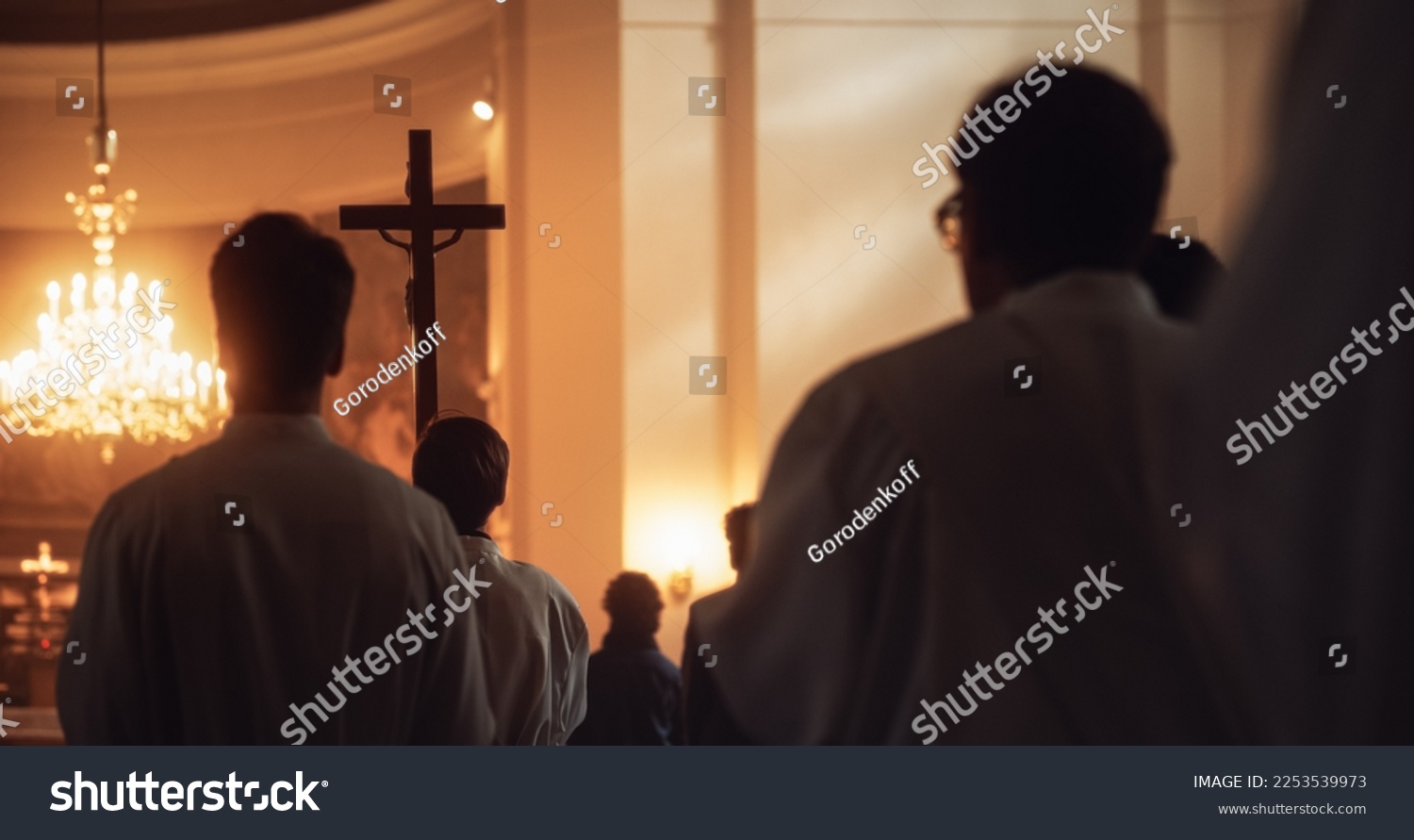 Liturgy In Church: Procession Of Ministers, Bearing Holy Cross to Altar, As Congregation Stands In Wonder. Christians Rejoice In Celebration Of Divine Mass. Hymns Praise God #2253539973
