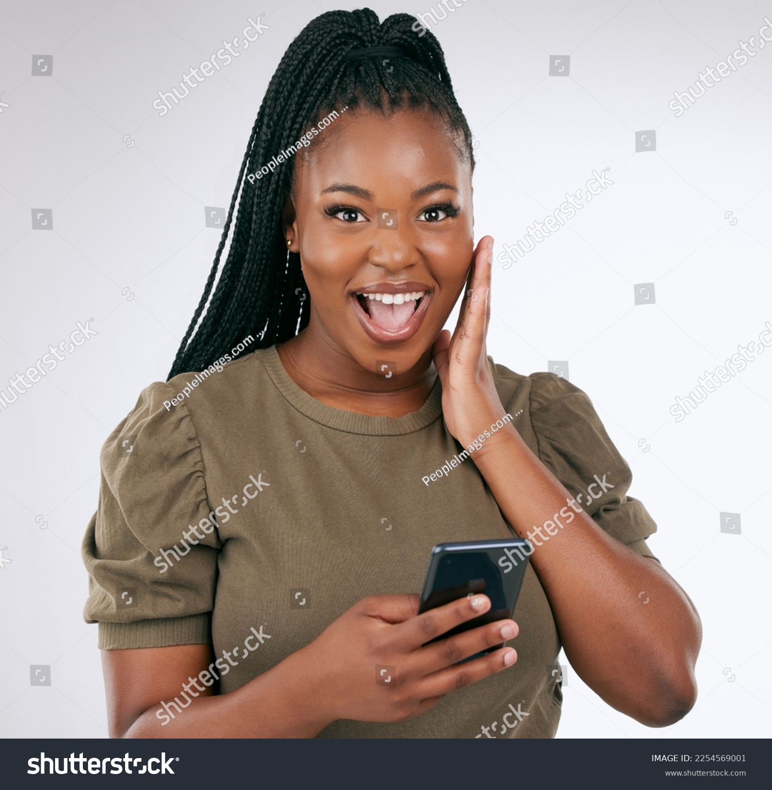 Black woman, surprise face in portrait with smartphone, wow facial expression isolated on gradient background. Happy in studio, notification on social media or email, alert or announcement with shock #2254569001