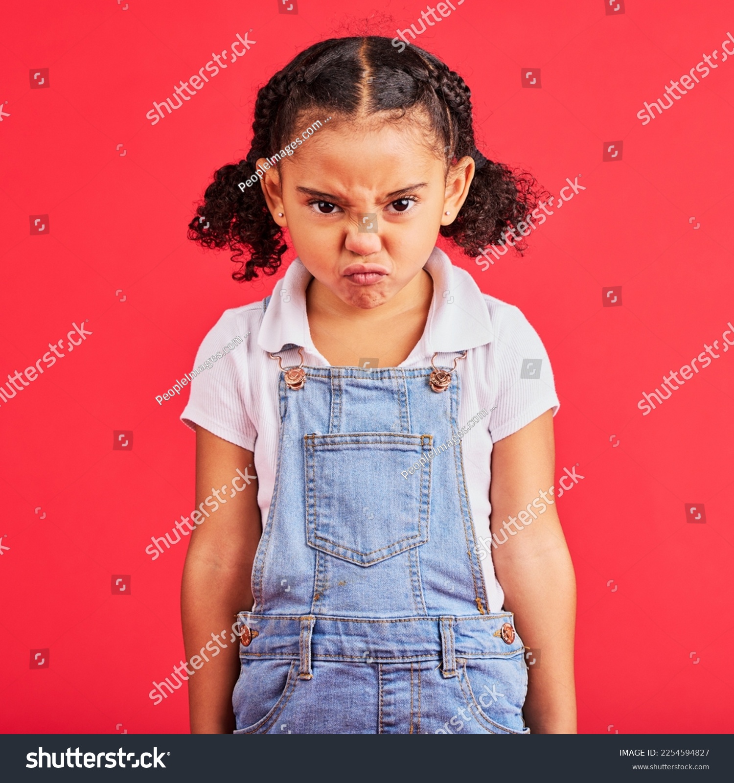 Child, portrait or angry face on isolated red background in emoji tantrum, behavior or stubborn studio problem. Mad, annoyed or frustrated little girl and sulking, grumpy or anger facial expression #2254594827