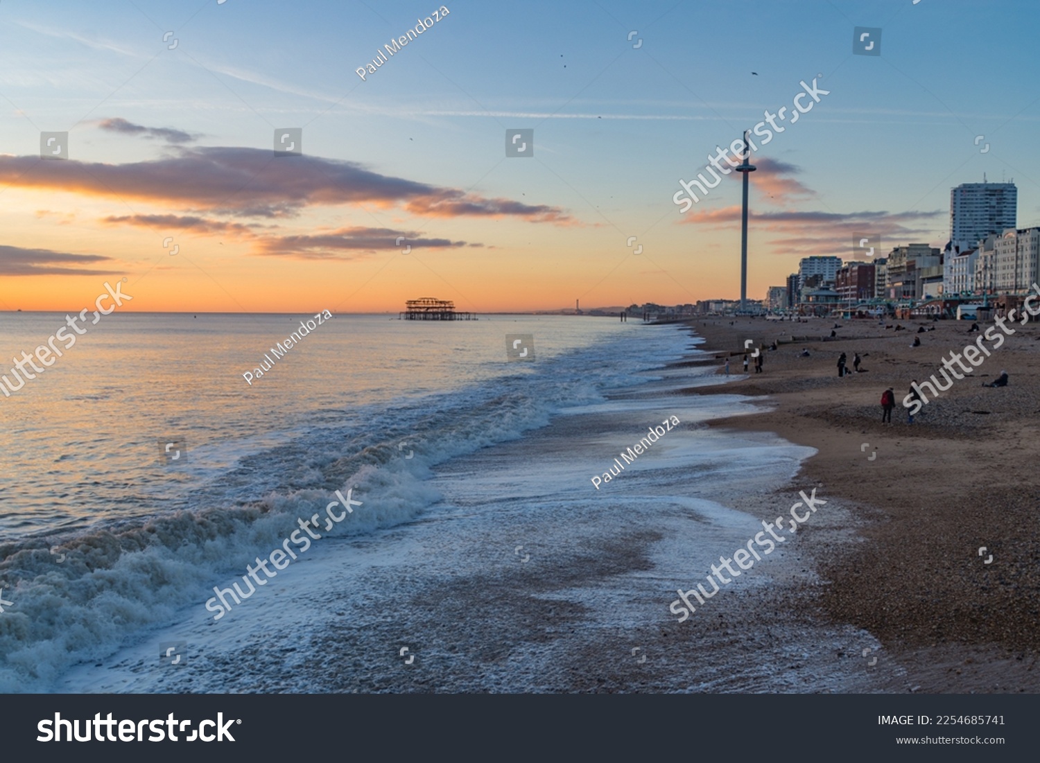 Brighton, UK - December 1st 2022: Brighton Beach during sunset with the i360 Observation Tower and derelict West Pier in the background. #2254685741