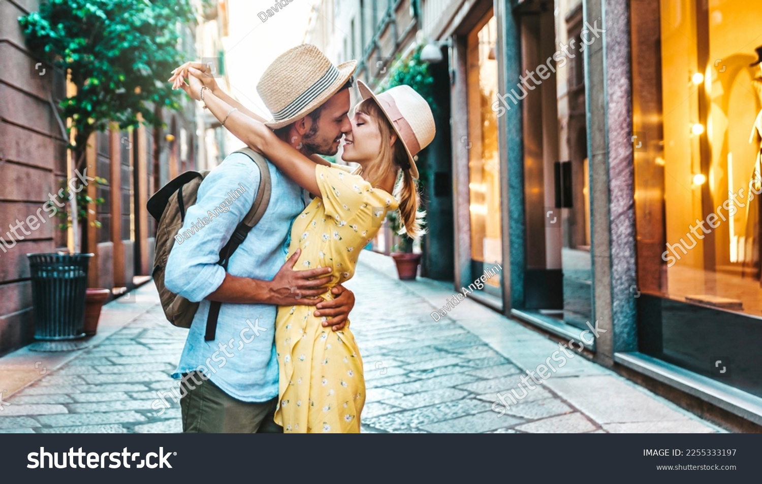 Couple of lovers kissing on city street - Two tourists enjoying romantic vacation together - Boyfriend and girlfriend dating outside - Love, tourism and life style concept #2255333197