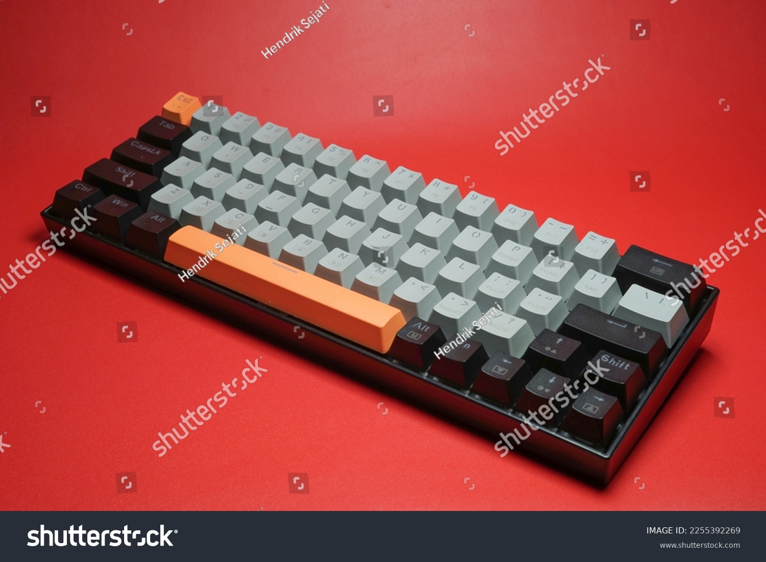 Mechanical keyboard with colorful keys and minimalist design on red background isolated #2255392269