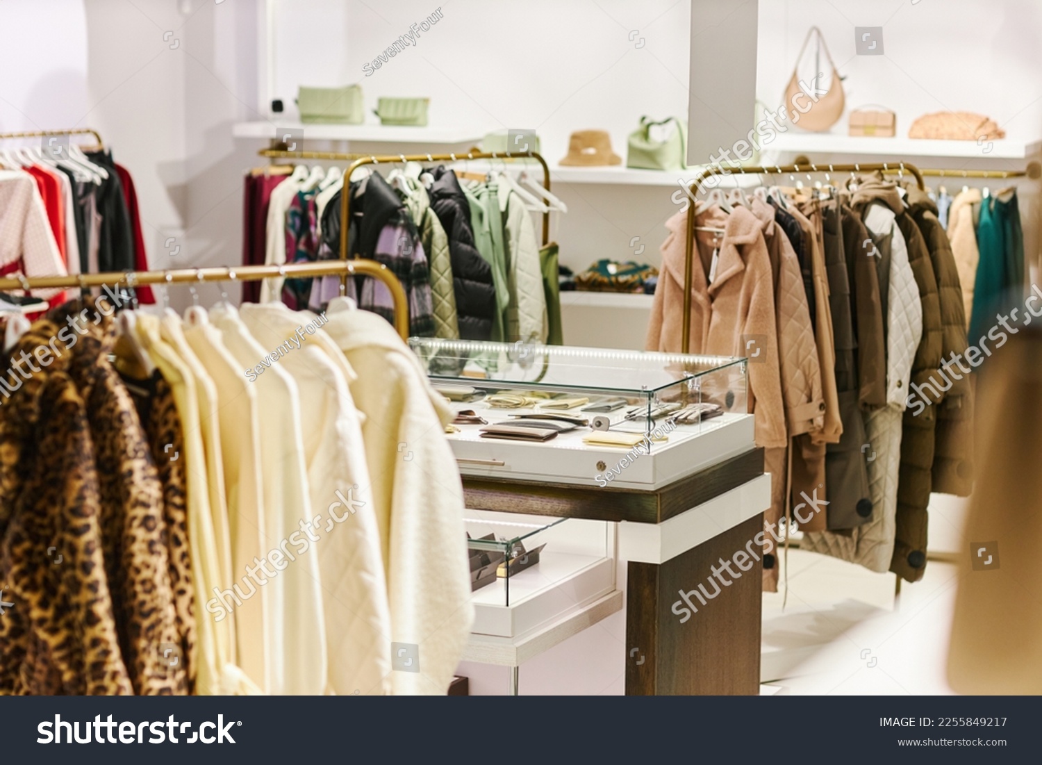 Background image of luxury boutique interior at shopping mall with clothes on hangers, copy space #2255849217