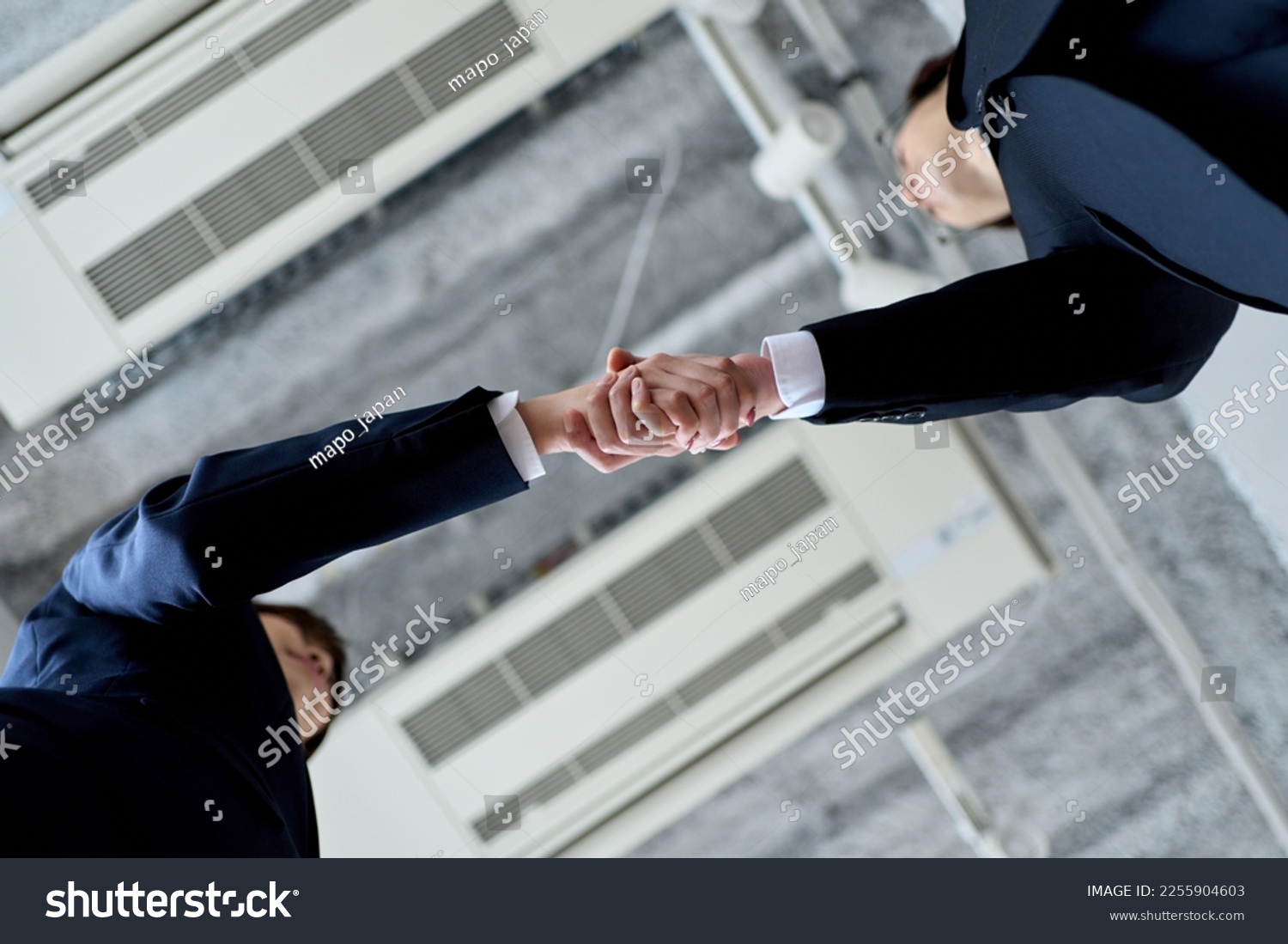 Male and female Asian business people shaking hands #2255904603