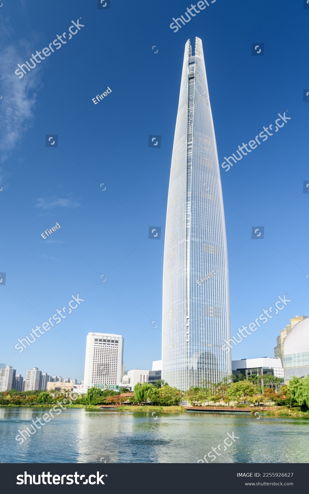 Beautiful view of skyscraper by lake at downtown of Seoul, South Korea. Amazing modern tower on blue sky background. Wonderful sunny cityscape. Seoul is a popular tourist destination of Asia. #2255926627