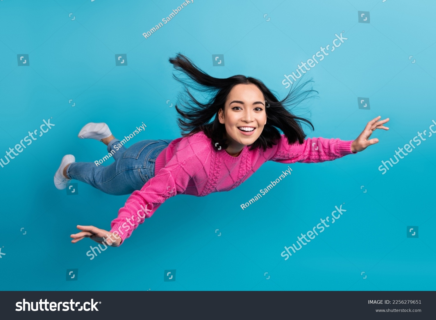 Full length photo of carefree adorable lady wear pink pullover arms wings flying air isolated blue color background #2256279651