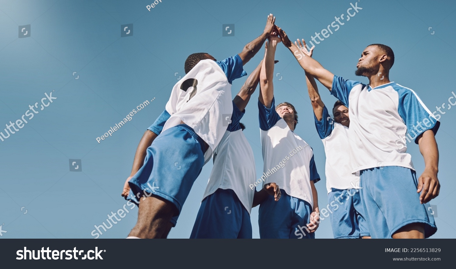 Soccer, team high five and men celebrate winning at sports competition or game with teamwork on field. Football champion group with motivation hands for a goal, performance and fitness achievement #2256513829
