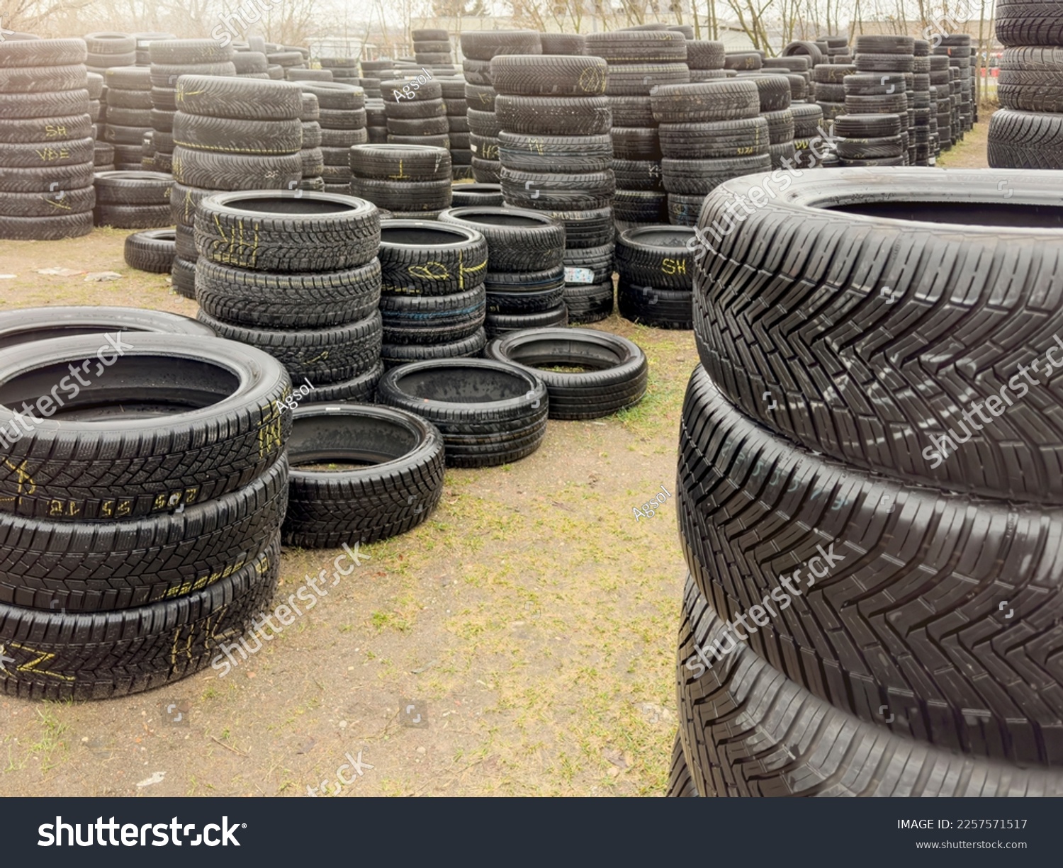 Used tires. Sale of used tires, stacks of different car tires lie on the ground. Buying used tires is a cheap alternative to new. #2257571517