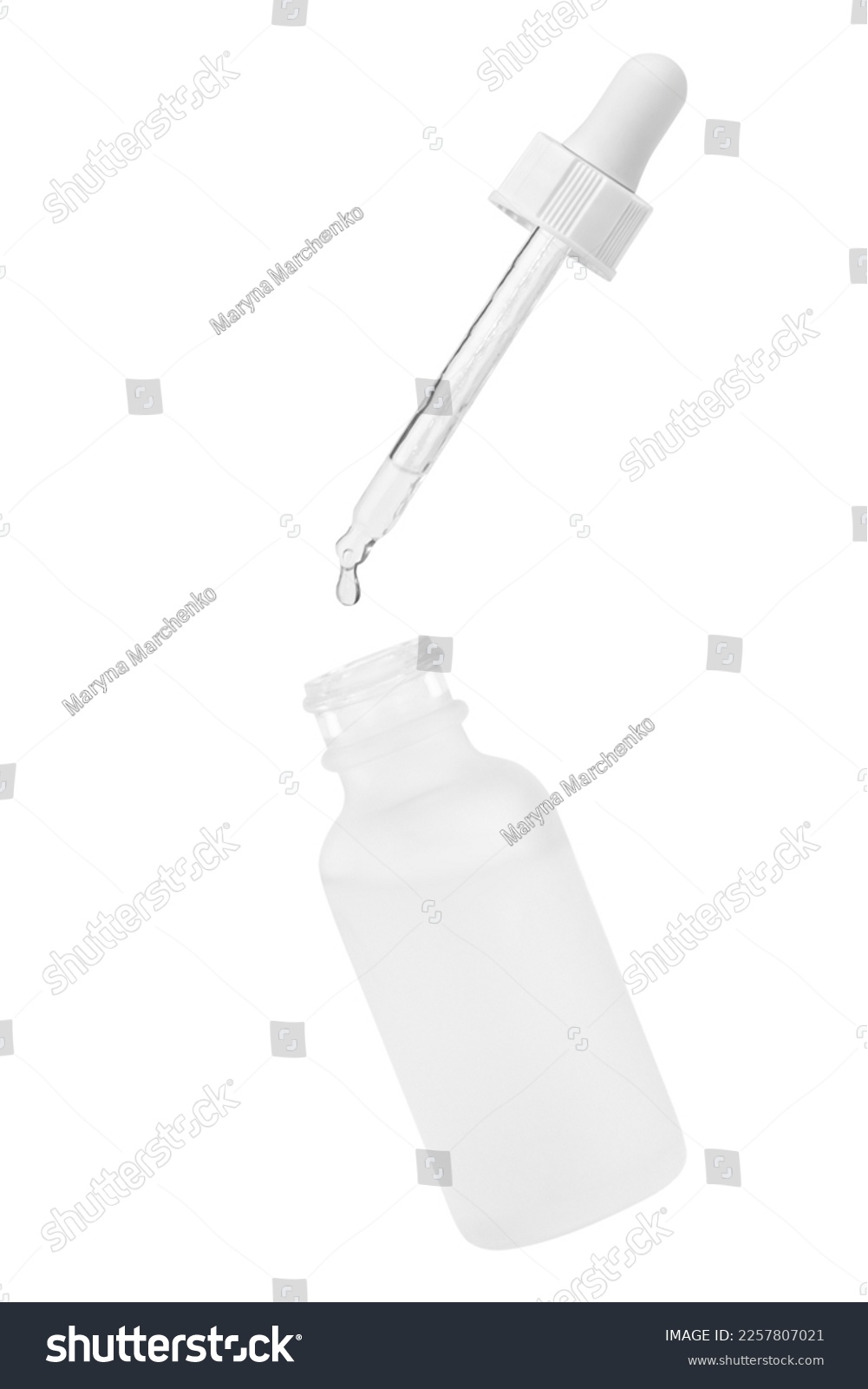 White cosmetic glass jar. Pipette with dripping outflowing liquid into a jar. Isolated on white background. Hyaluronic acid. Serum for the face. Hydration. #2257807021