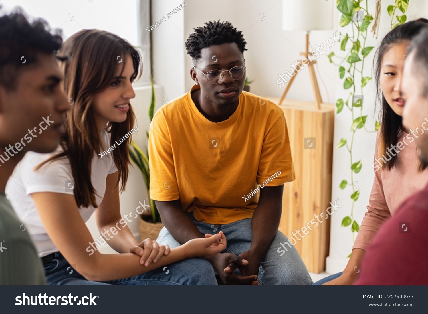 Multiracial people sitting in circle during group therapy supporting each other. Diversity, mental health and support concept. People communicating while sitting in circle and gesturing. #2257930677