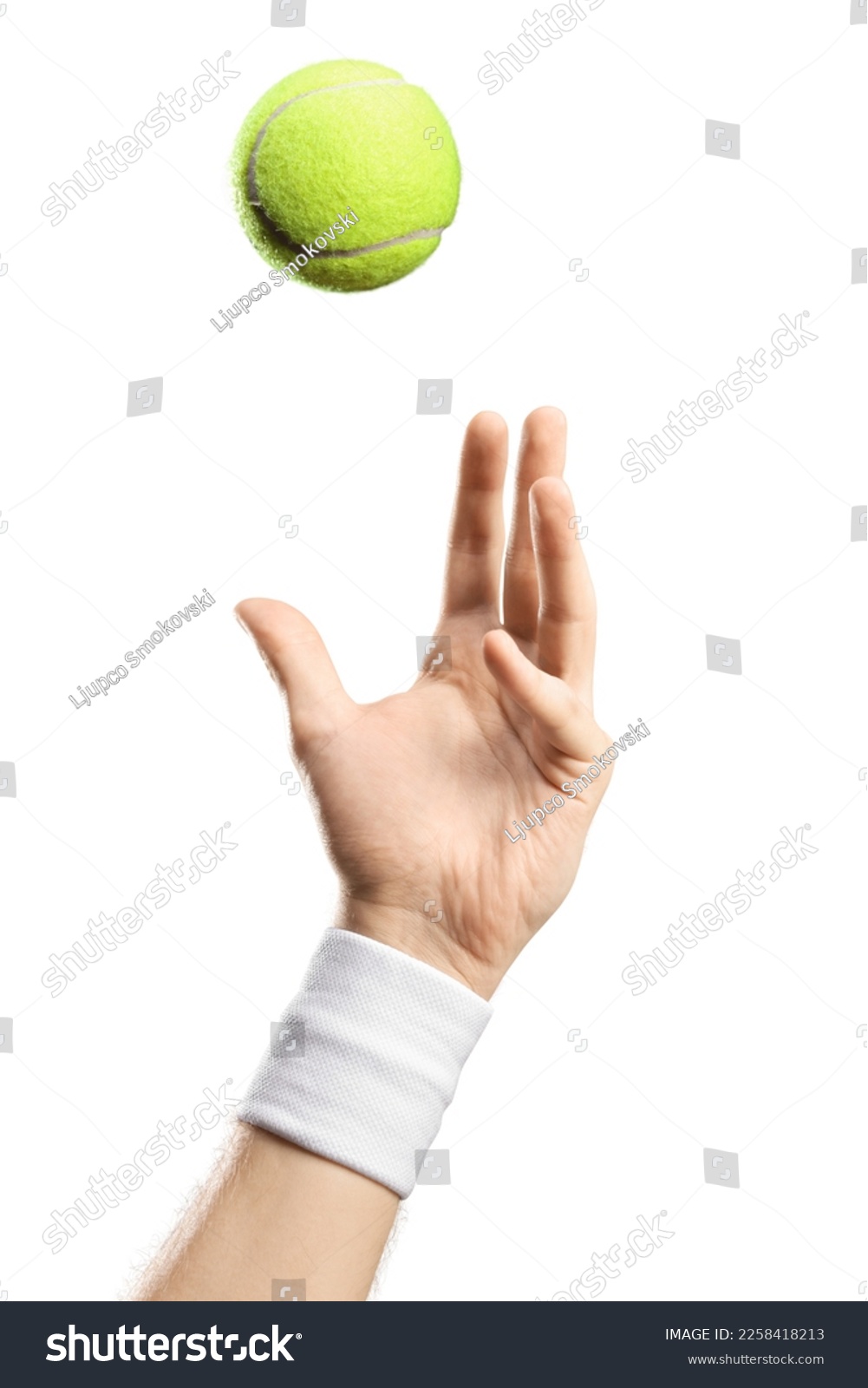 Male hand with a wristband throwing a tennis ball isolated on white background #2258418213