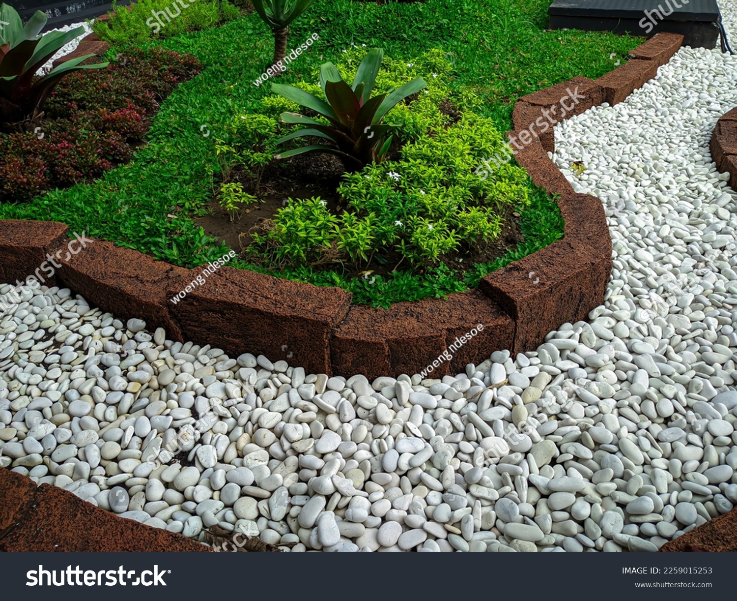 Modern front yard with beautiful garden and white stone garden #2259015253