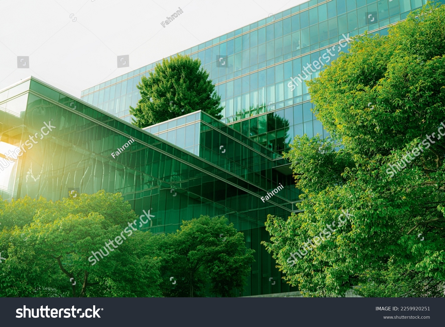 Sustainable green building. Eco-friendly building. Sustainable glass office building with tree for reducing carbon dioxide. Office with green environment. Corporate building reduce CO2. Safety glass. #2259920251