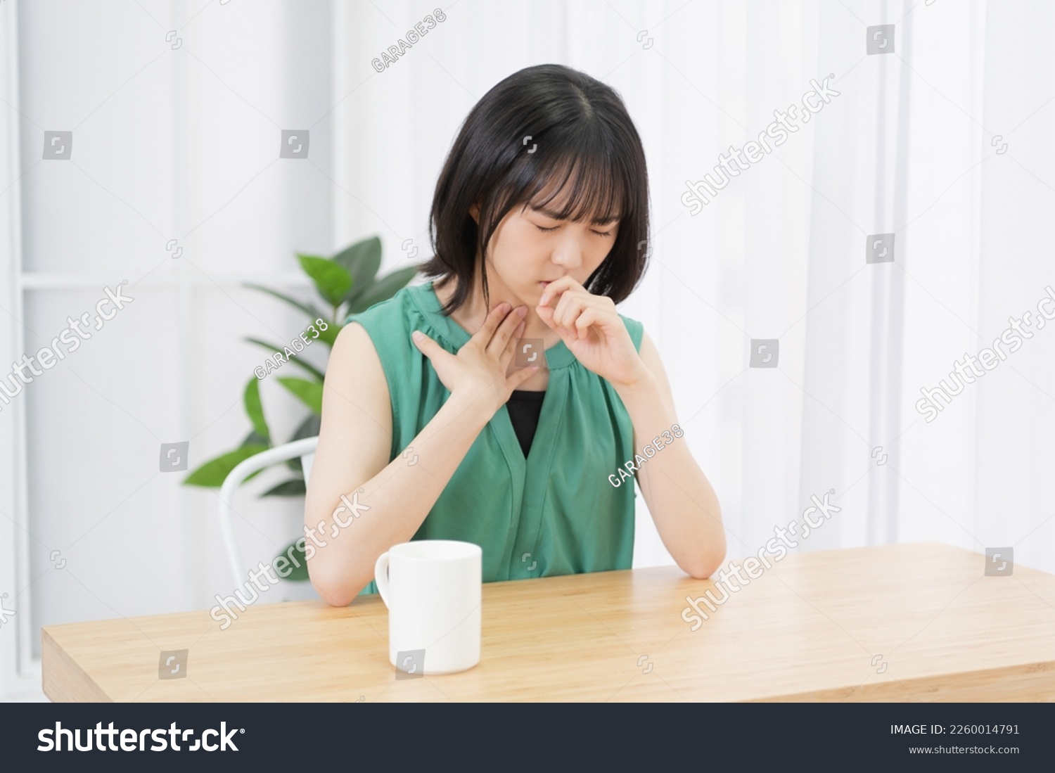 young woman with sore throat #2260014791